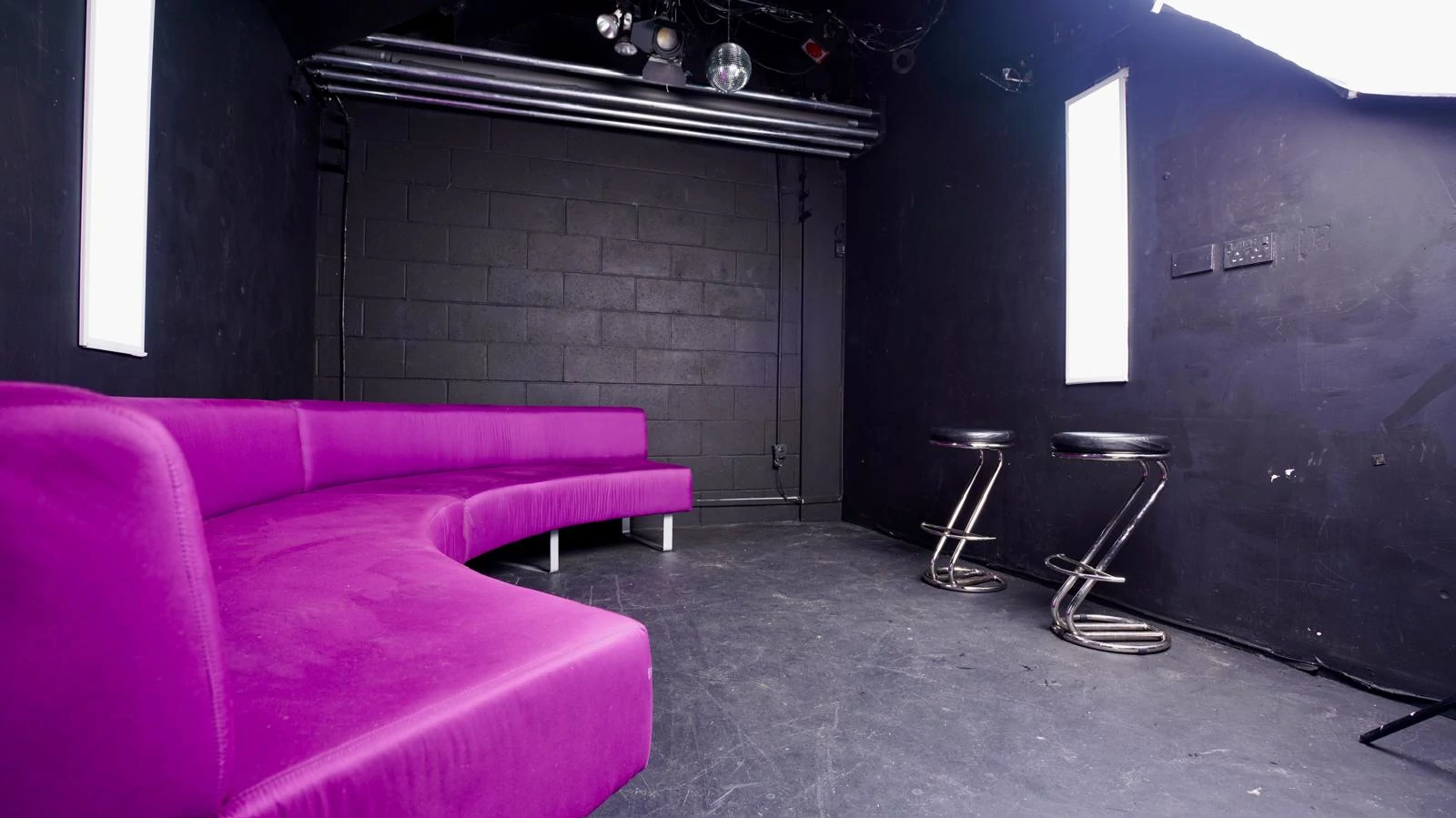 black studio purple sofa black stools 