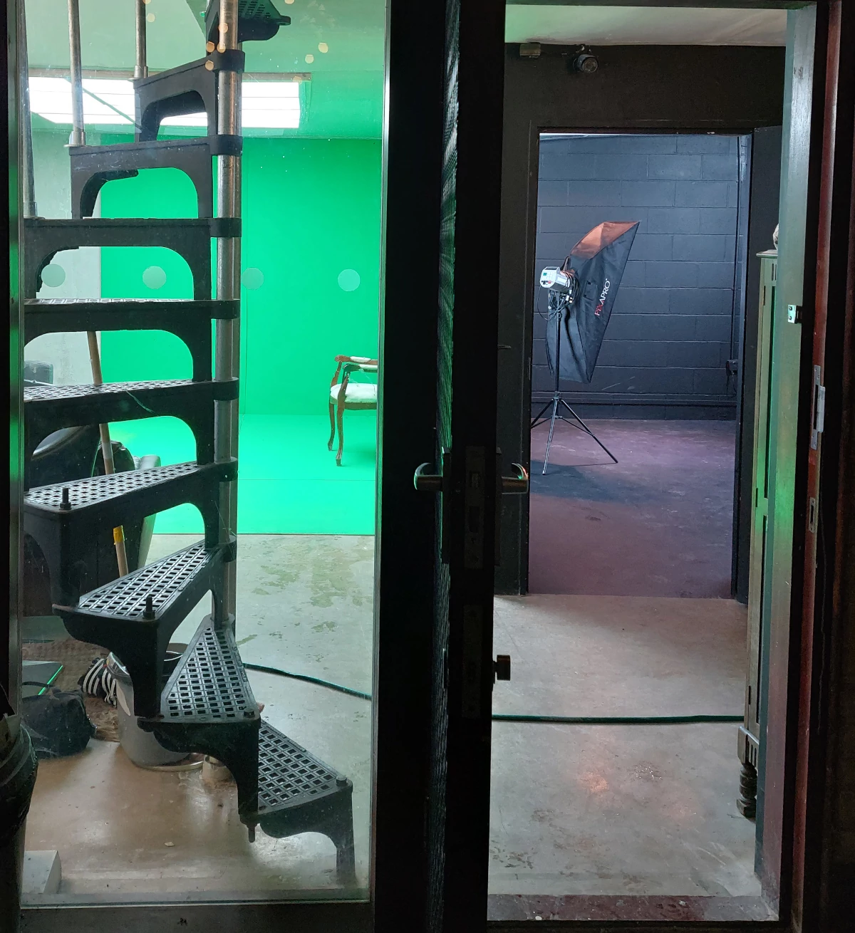 green screen and black studio through back door 